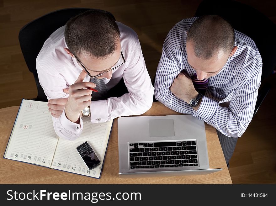 Two businessmen working at laptop. Two businessmen working at laptop