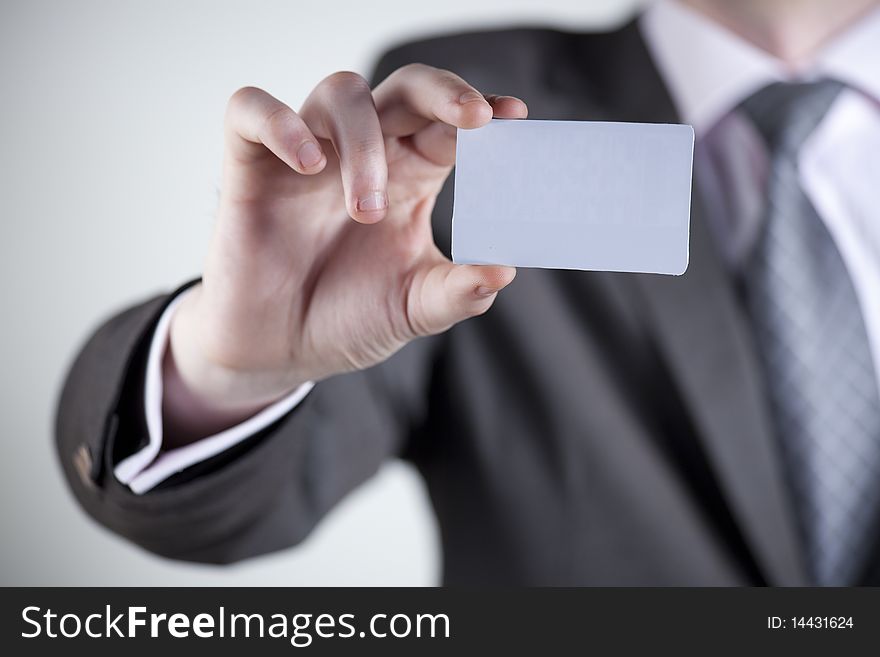 Hand of business man offering business card