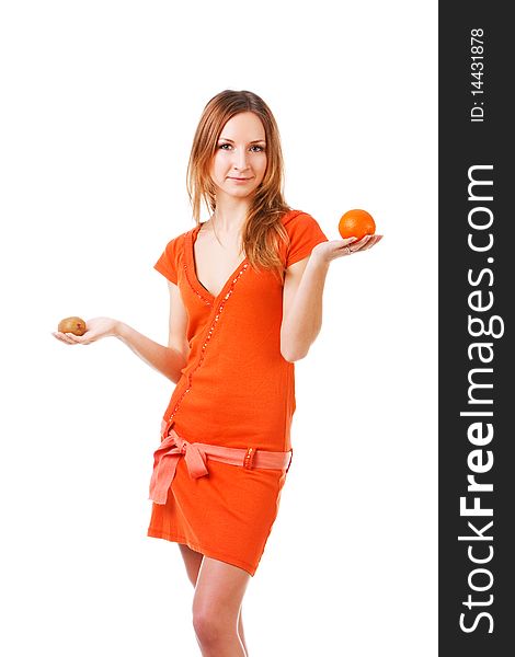 Picture of a young pretty girl in dress which holds orange and kiwi in different hands. Isolated on white. Picture of a young pretty girl in dress which holds orange and kiwi in different hands. Isolated on white.