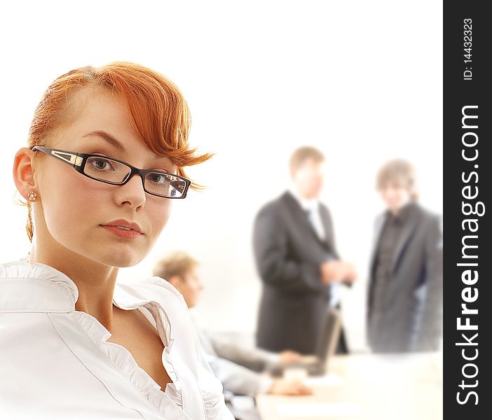 A redhead business woman in front of a meeting