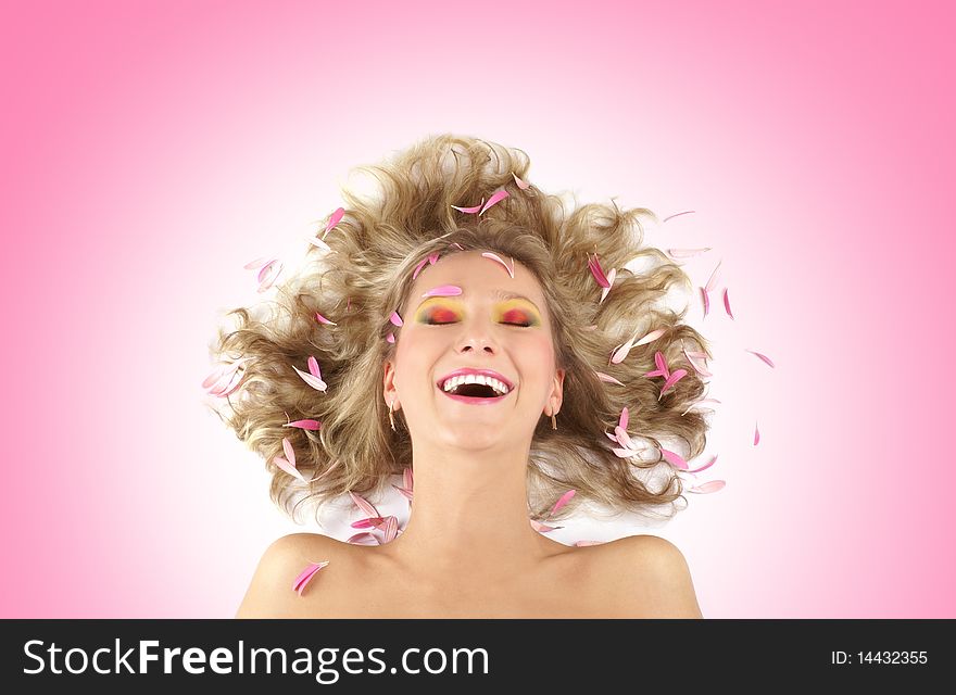Portrait of a young and happily laughing blonde. Image isolated on a pink gradient background. Portrait of a young and happily laughing blonde. Image isolated on a pink gradient background.