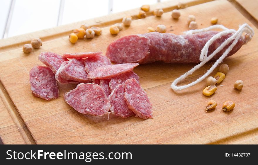 Sausage with  on a kitchen board. Fuet spain. Sausage with  on a kitchen board. Fuet spain.