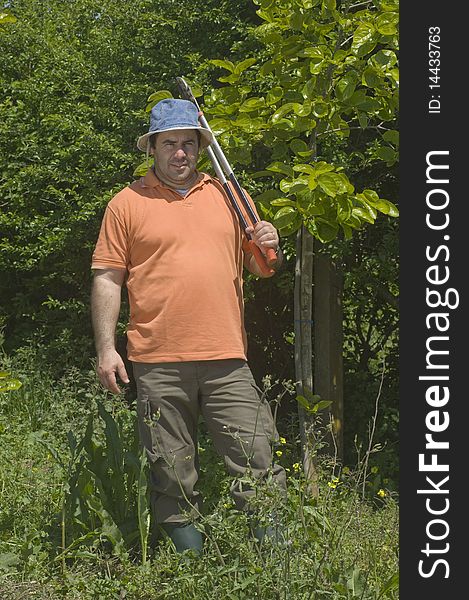 Farmer working on the farm with a pruning shears