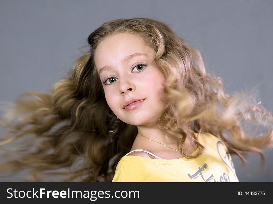 Portrait of a beautiful teenager. Isolated on grey background