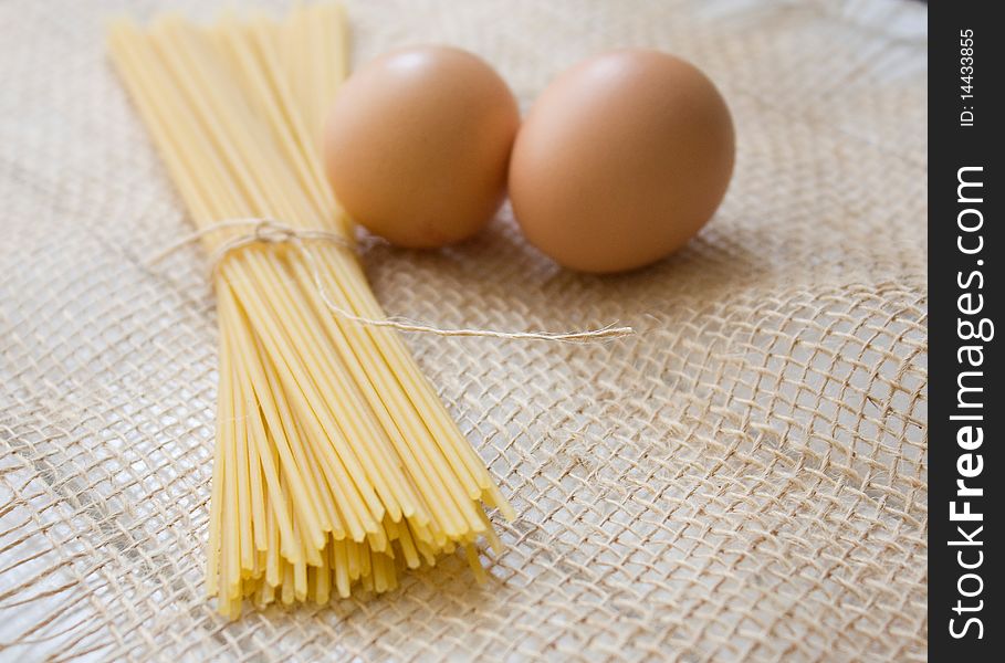 Pasta and egg on the natural sackcloth. Pasta and egg on the natural sackcloth