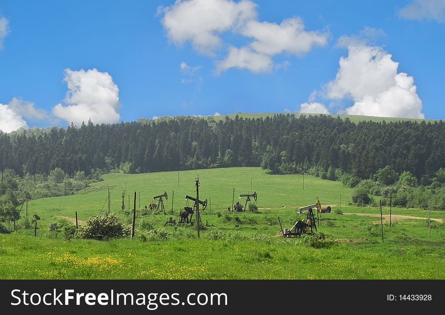 Oil pumps are in the valley of mountains