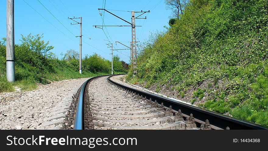 Railway surrounded by greenery and blue sky. Railway surrounded by greenery and blue sky