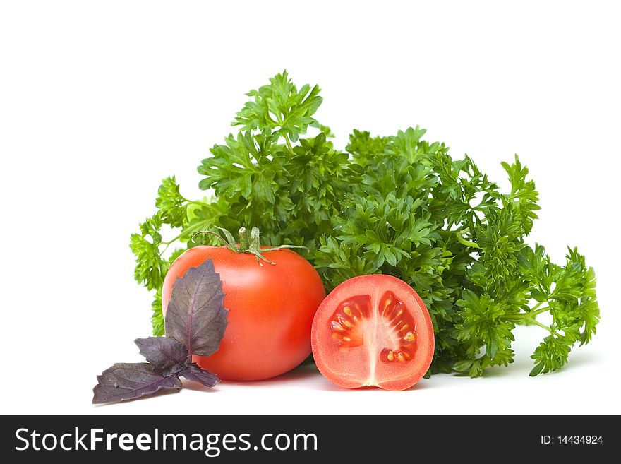 Tomatoes and parsley on a white background. Tomatoes and parsley on a white background