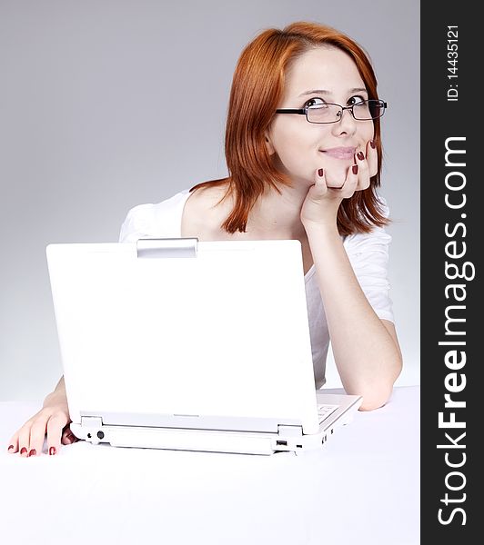 Red-haired girl with white notebook. Studio shot.