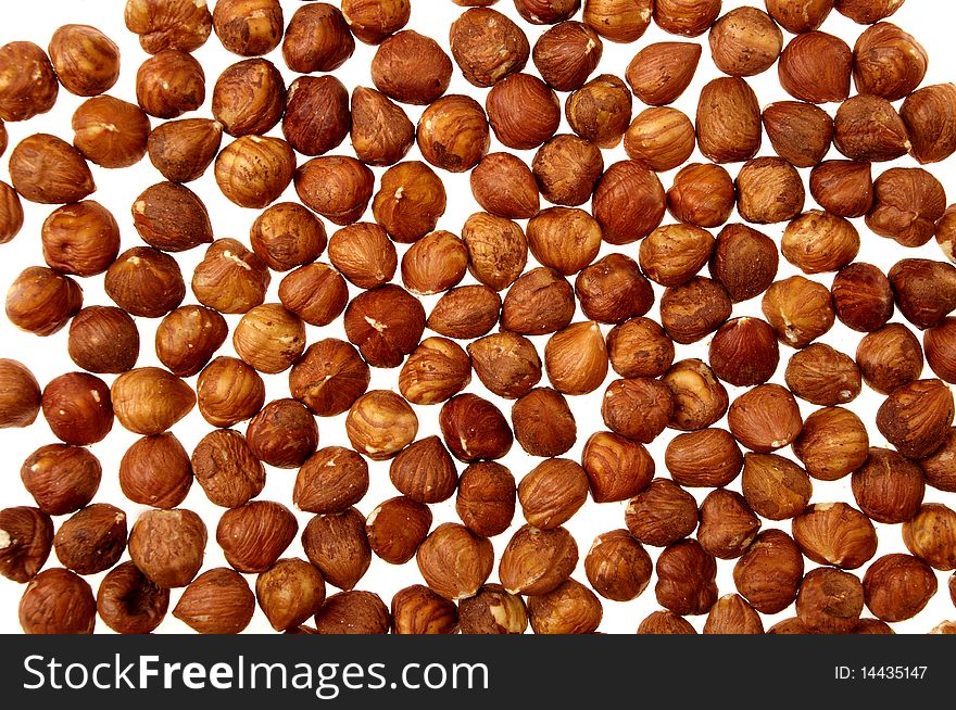 Shelled hazelnuts on white background