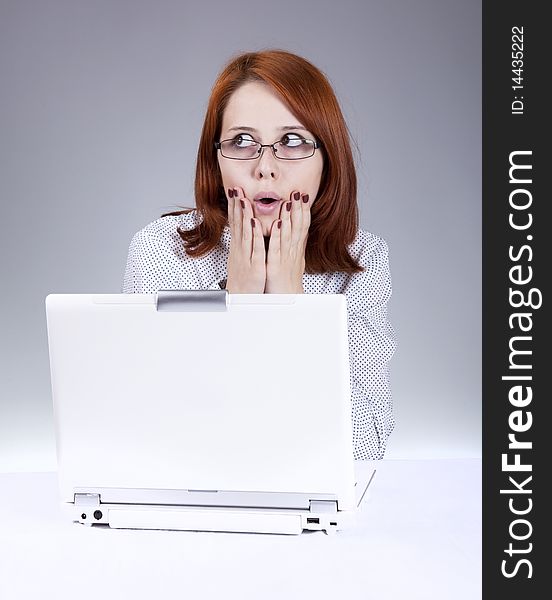 Red-haired girl with white notebook. Studio shot.