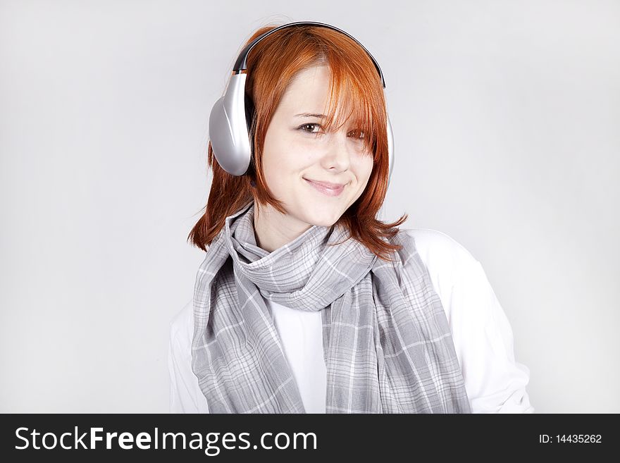 Girl with modern headphones. Studio shot.