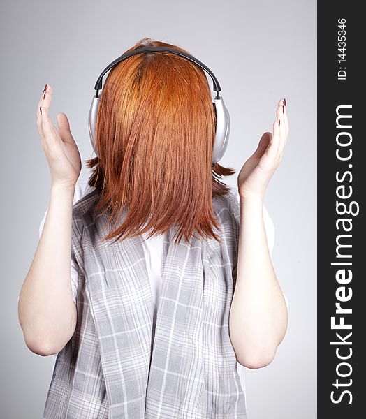 Unusual red-haired girl with headphones.