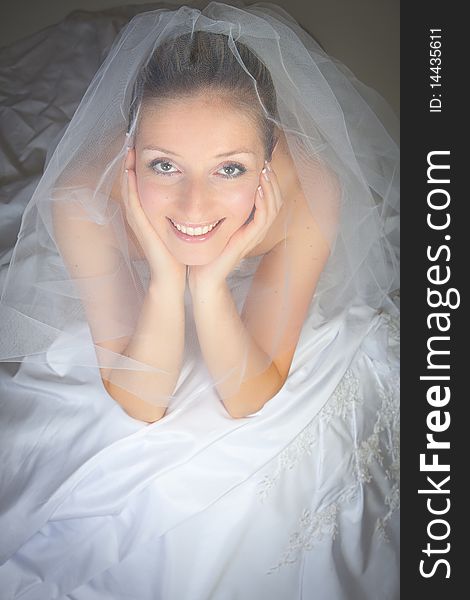 Young woman in wedding dress in studio