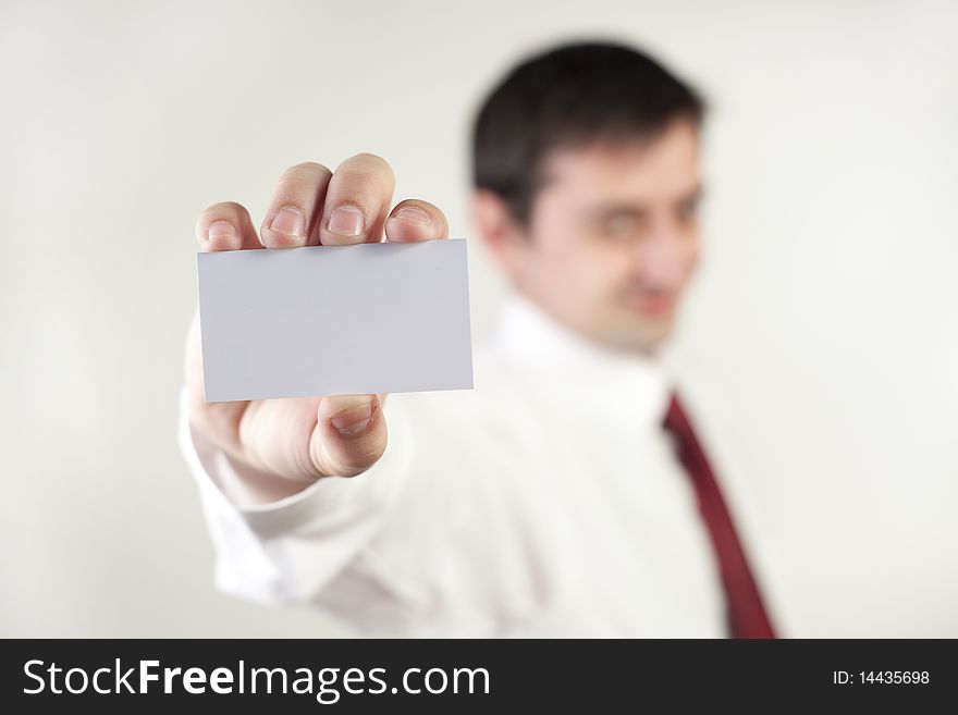 Young businessman showing his card. Young businessman showing his card