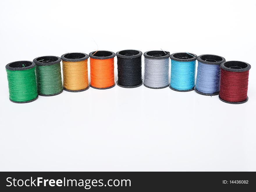 Colorful thread spools on a white background. Colorful thread spools on a white background.