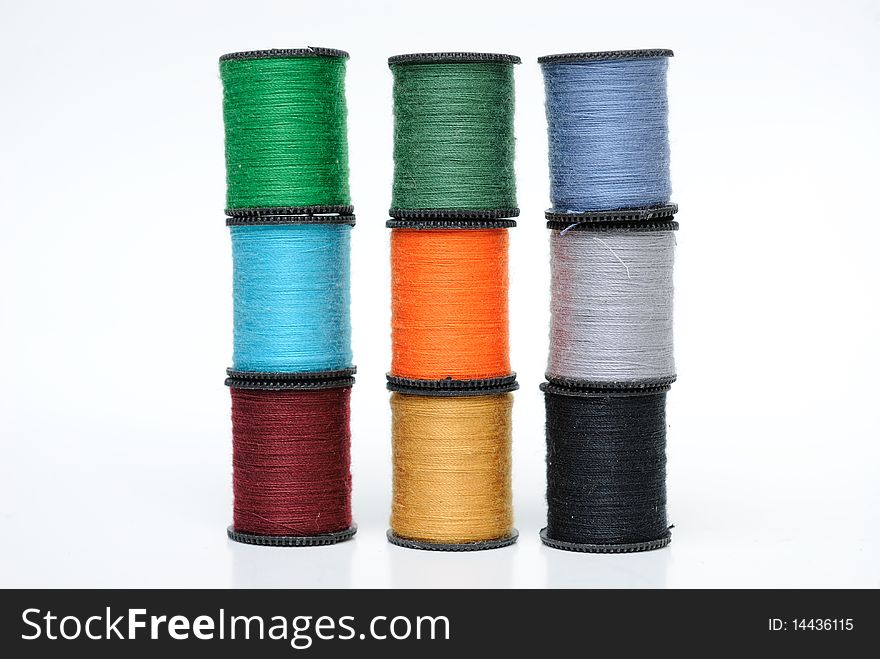 Colorful thread spools on white. Colorful thread spools on white.