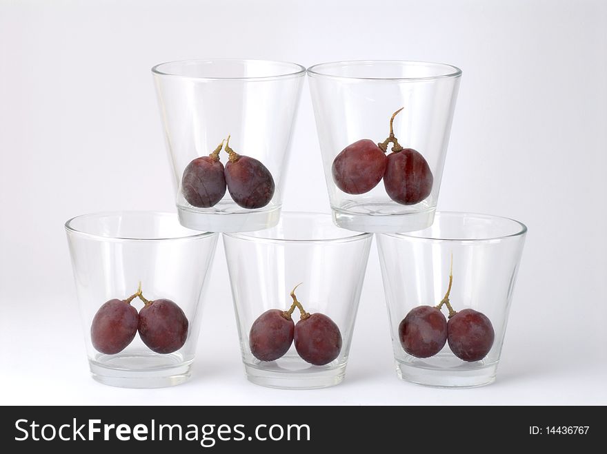 five glasses with cherries inside
