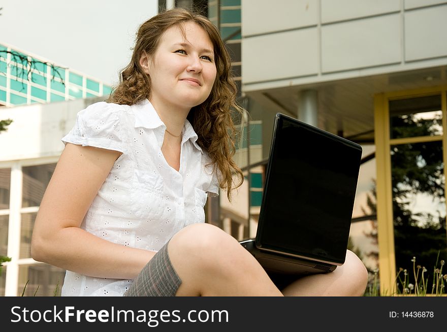 Outdoor portrait of adorable woman with laptop. Outdoor portrait of adorable woman with laptop