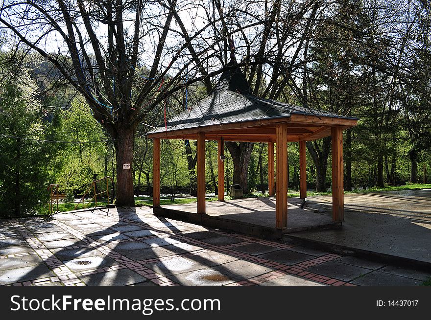 Arbour for rest next to a tree giving shade