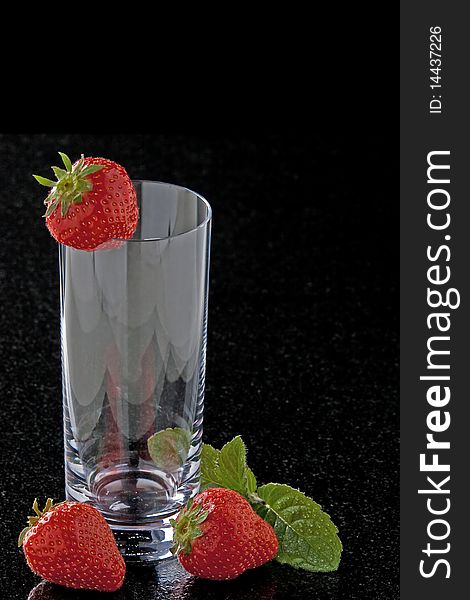 Glass with strawberries and mint leaves