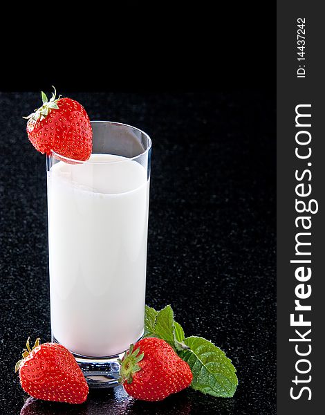 Glass with milk strawberries and mint leaves. Glass with milk strawberries and mint leaves