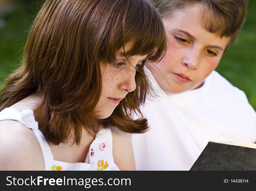 Portrait Of Cute Kids Reading Books