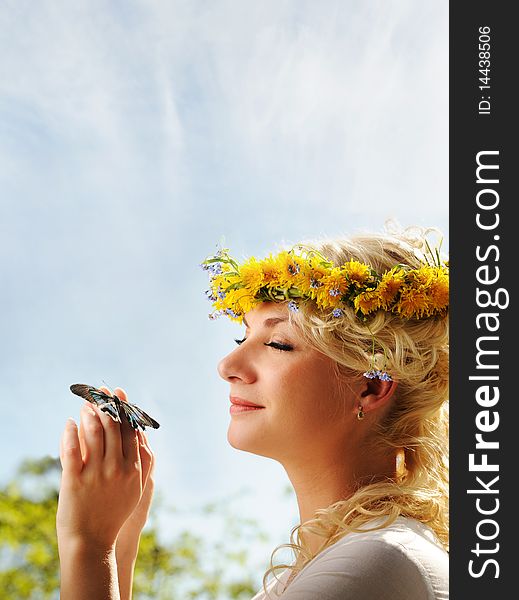 Lovely woman with a butterfly over blue sky