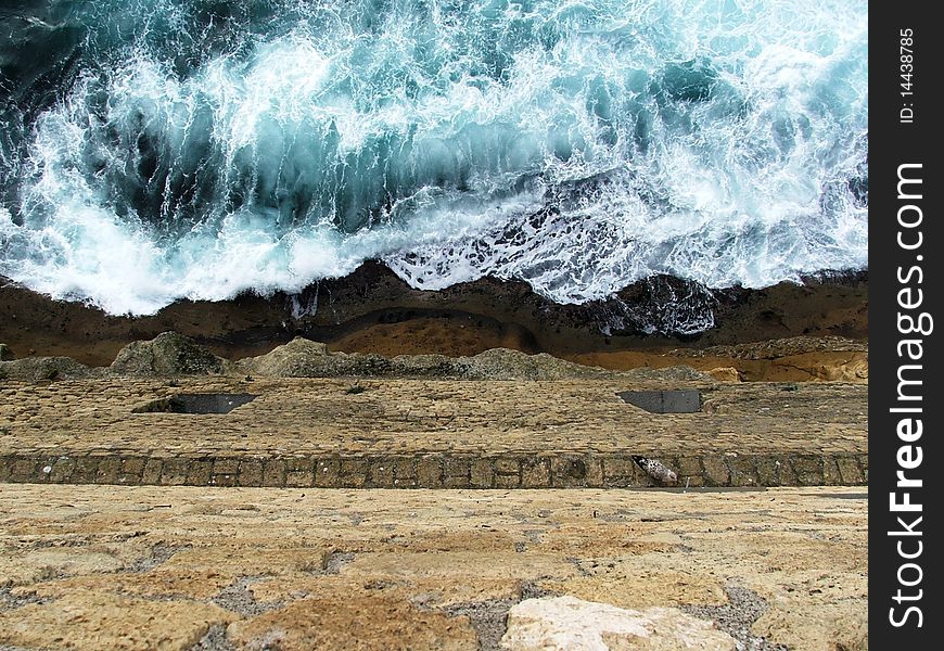 The sea and the yellow rocks of the neapolitan Castel dell'Ovo, in a eternous fighting. The sea and the yellow rocks of the neapolitan Castel dell'Ovo, in a eternous fighting