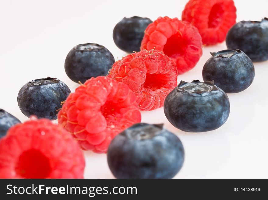 Raspberries and blueberries in a row