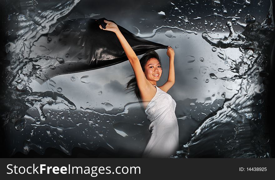 Woman holding fabric with abstract water splash. useful for showing beauty, woman, abstract, and exploratory ideas.