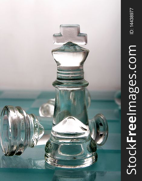 Glass chess king on white background