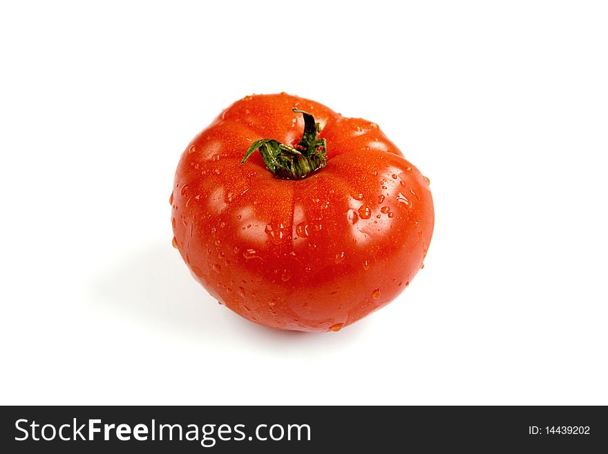 Fresh and wet tomato on white background