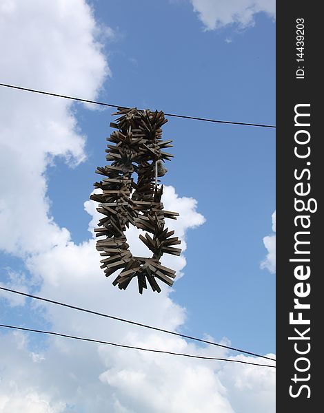 Old wooden clothespins hanging, in the background beautiful sky