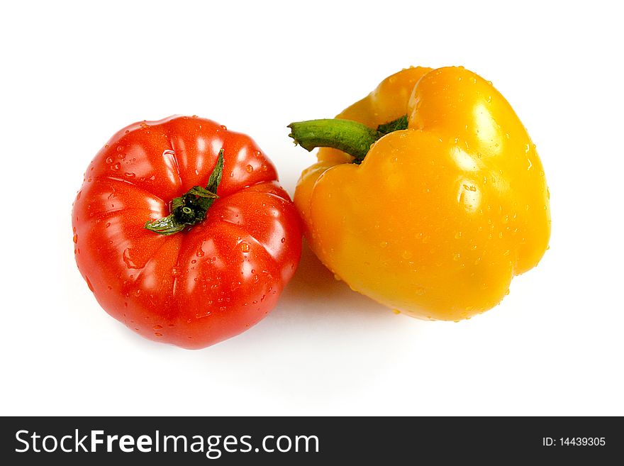 Tomato and yellow paprika close-up on white background