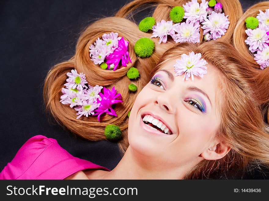 Young laughing girl with flowers in hair