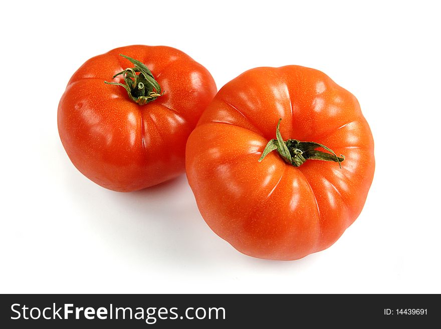 Two fresh tomatos on white background