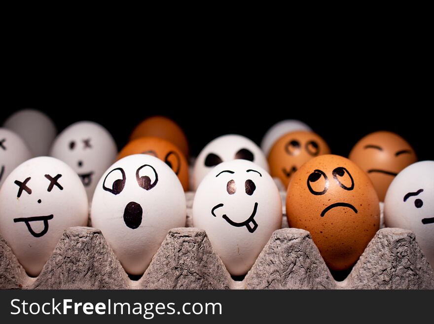 Eggs with funny expressions simulating human faces. Concept of ethnic diversity and moods