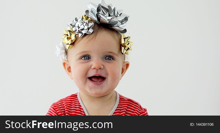 Baby decorated with a bow as a gift on a white background