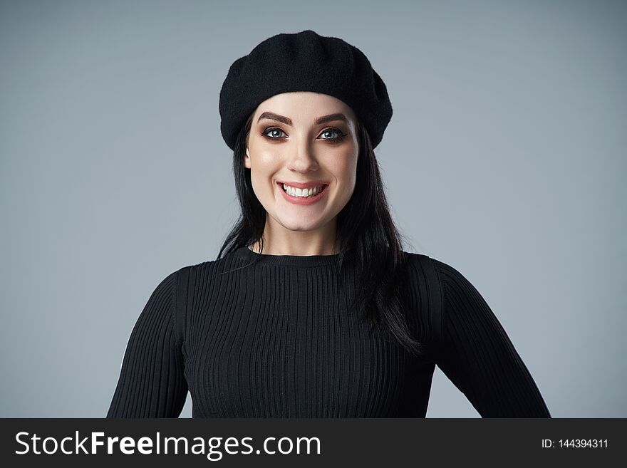 Portrait of smiling brunette girl in beret