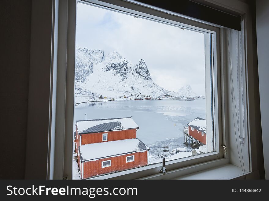 Incredibly beautiful view from the window of the house, an incredibly beautiful landscape of mountains, seas and boats in the winter in Norway on the Lofoten Islands