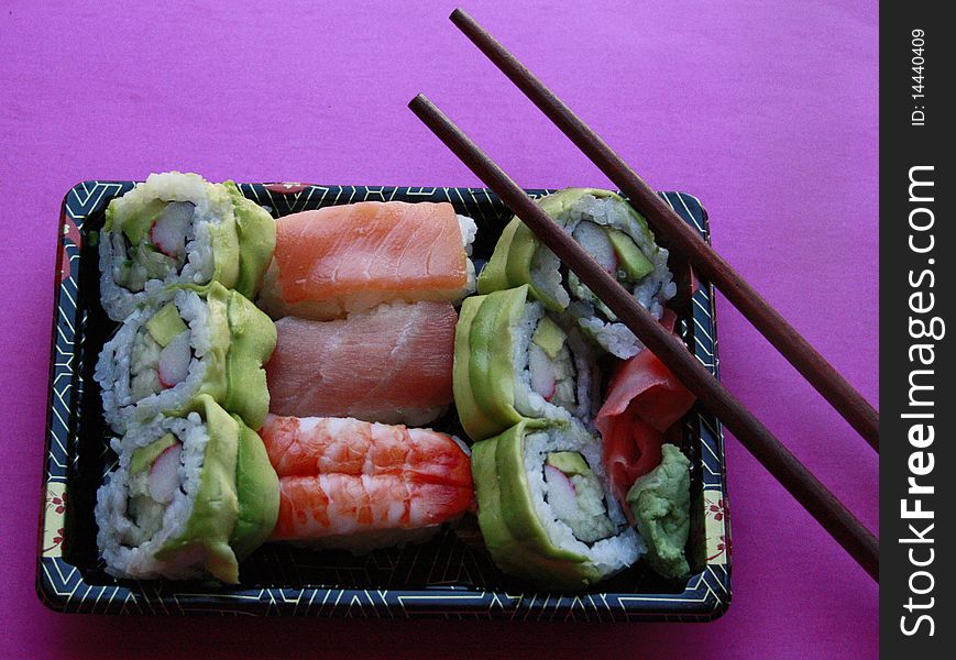 Sushi rolls in plastic black tray. Sushi rolls in plastic black tray