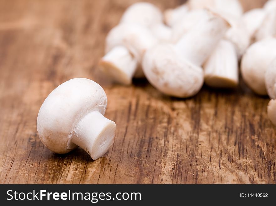 Fresh champignon on wooden background