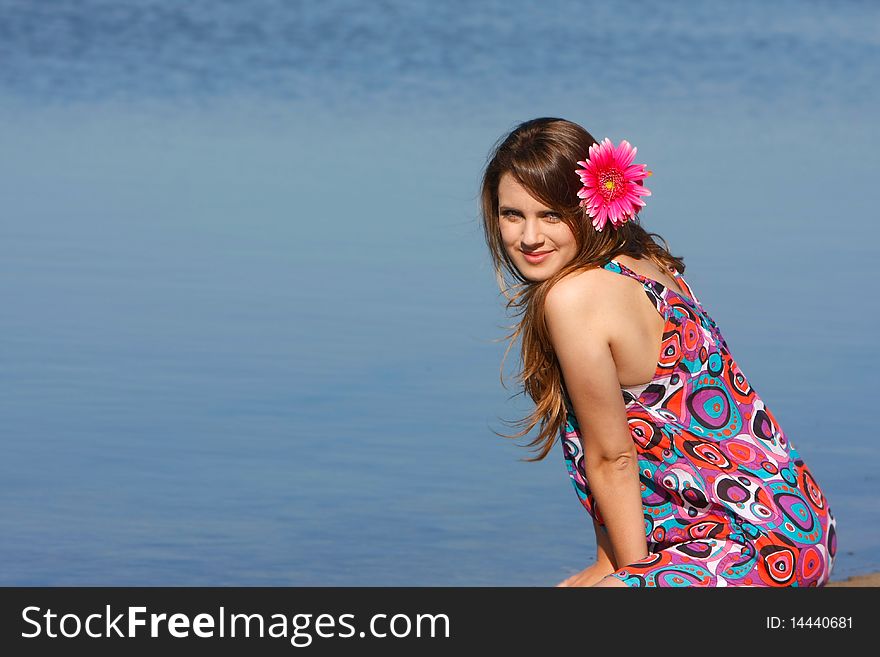 Young beautiful girl on sea background