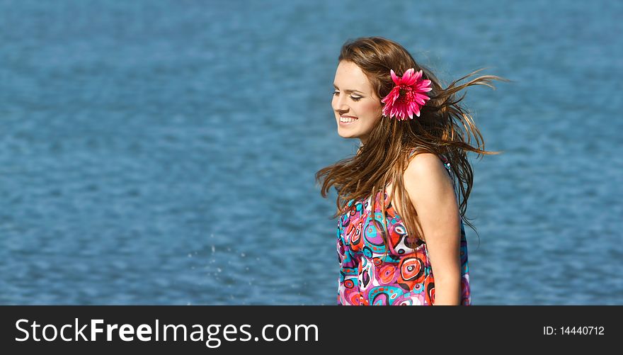 Young happy girl on sea background