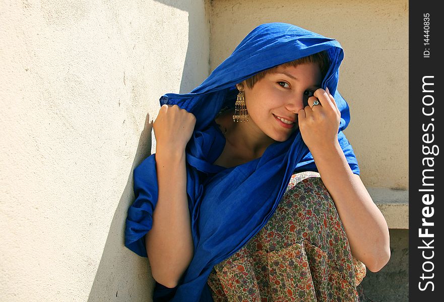 Beautiful young woman in blue headscarf and ear-ring. Beautiful young woman in blue headscarf and ear-ring