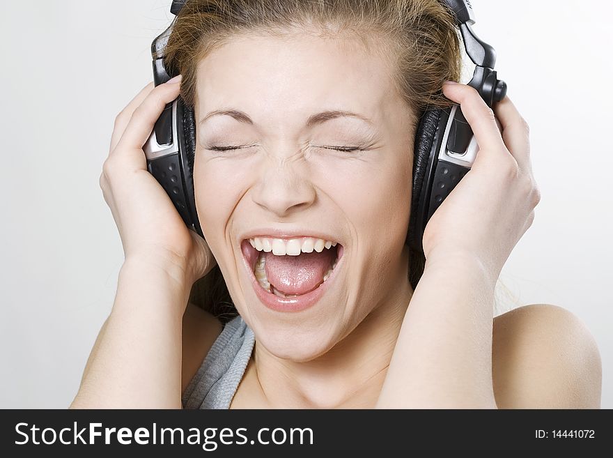 Woman listening music with big headphones and singing. Woman listening music with big headphones and singing