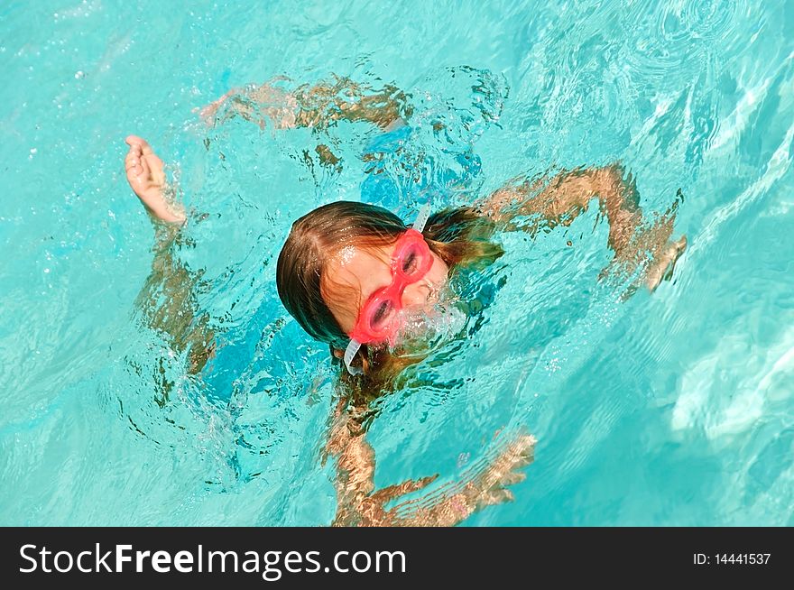 Young Girl Playing In A Pool