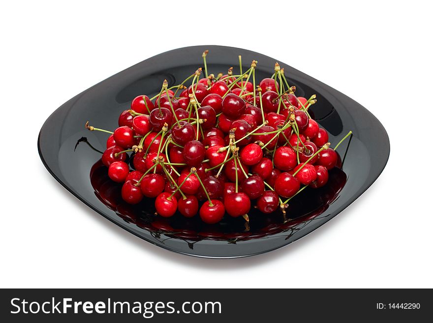 Fresh ripe cherry berry in black glass dish