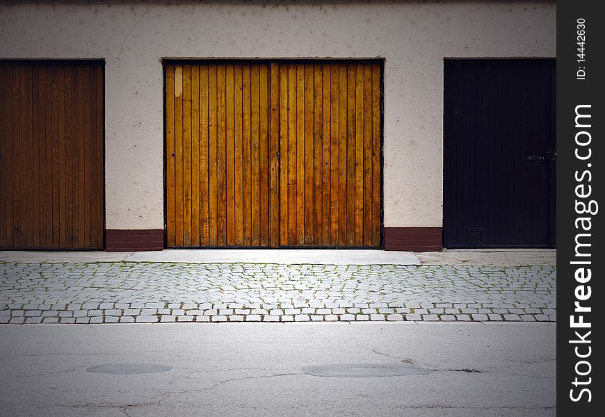 Three garage doors, centered on the middle brown